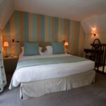 un lit assis dans une chambre à côté d'une fenêtre